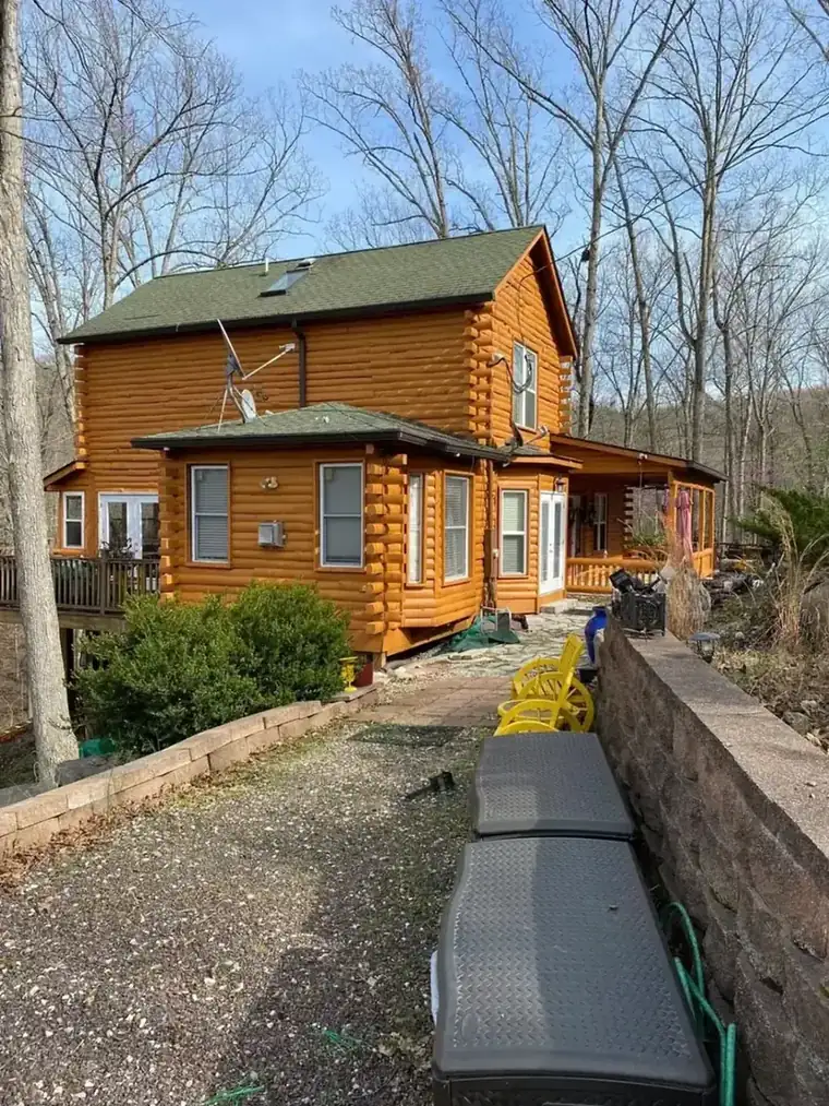 Log home after premium re-stain by Nye Builders