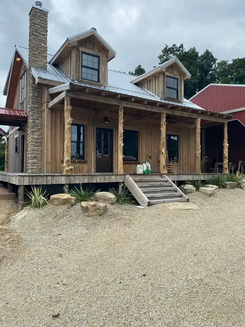 Custom log cabin build with cedar porch posts by Nye Builders
